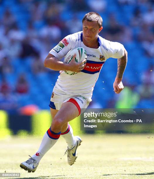 Wakefield Wildcats' Tim Smith breaks past Castleford Tigers Brett Ferris to score his try during the Stobart Super League, Magic Weekend match at the...