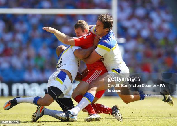 Warrington Wolves' Matty Blythe and Trent Waterhouse tackle Widnes Vikings' Cameron Phelps during the Stobart Super League, Magic Weekend match at...