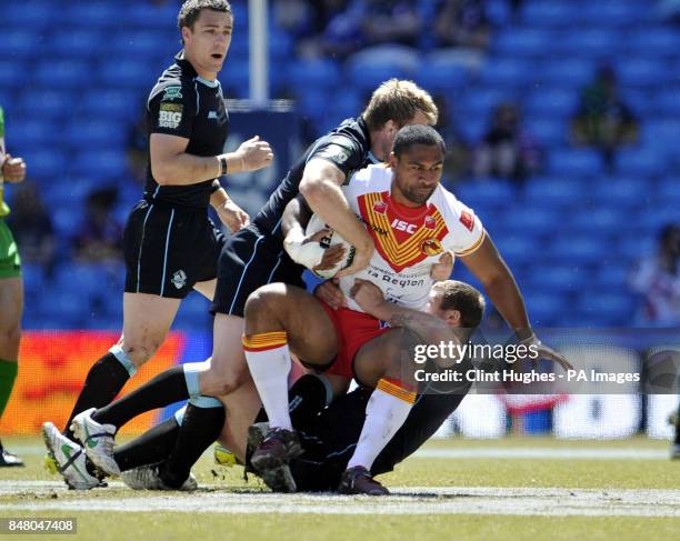 Catalan Dragons' Lopini Paea is tackled by the London Broncos defence during the Stobart Super League, Magic Weekend match at the Etihad Stadium,...