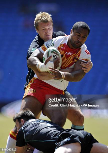 Catalan Dragons Lopini Paea is tackled by the London Broncos defence during the Stobart Super League, Magic Weekend match at the Etihad Stadium,...