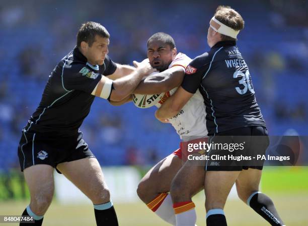 Catalan Dragons Lopiini Paea is tackled by London Broncos Omari Caro and Scott Wheeldon during the Stobart Super League, Magic Weekend match at the...