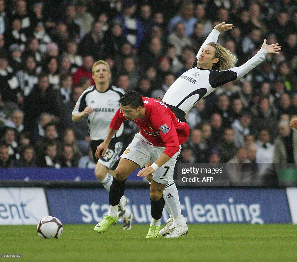 Robbie Savage (R) of Derby tackles Portu