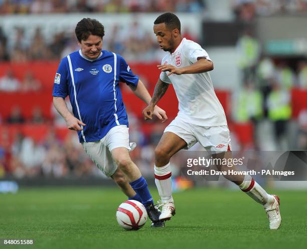 Mike Myers and Aston Merrygold during the match at Old Trafford for Soccer Aid.