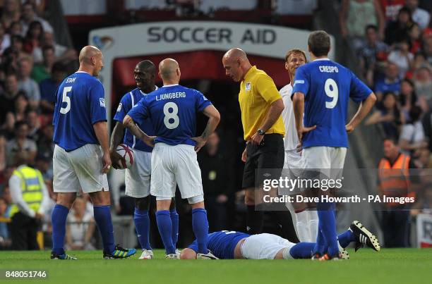 Gordon Ramsay lies injured during the match at Old Trafford for Soccer Aid.