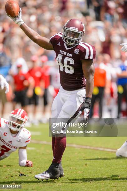 Texas A&M Aggies defensive lineman Landis Durham celebrates a fumble recovery during the college football game between the Louisiana Ragin' Cajuns...