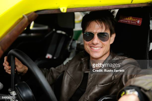 Actor Tom Cruise sits inside the car used in the film "Days of Thunder" on track prior to the start of the NASCAR Sprint Cup Series Daytona 500 at...