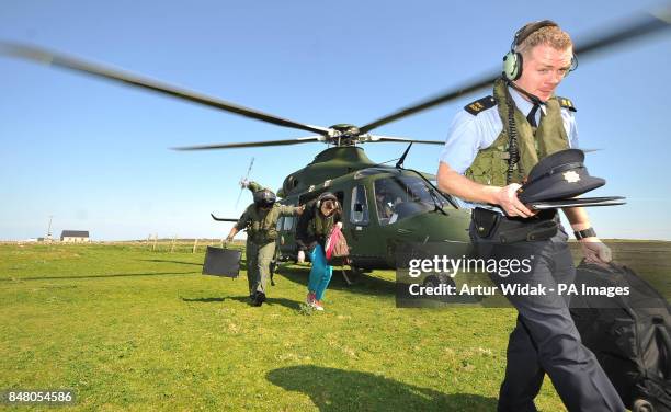 Garda Eugene Organ leaves the polling station with the ballot box after voting on the fiscal treaty referendum on Tory Island off the coast of...