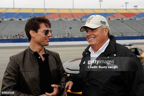 Actor Tom Cruise speaks with team owner Rick Hendrick prior to the start of the NASCAR Sprint Cup Series Daytona 500 at Daytona International...