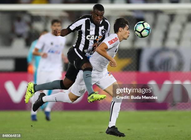 Marcelo Conceio of Botafogo struggles for the ball with Noguera of Santos during a match between Botafogo and Santos part of Brasileirao Series A...