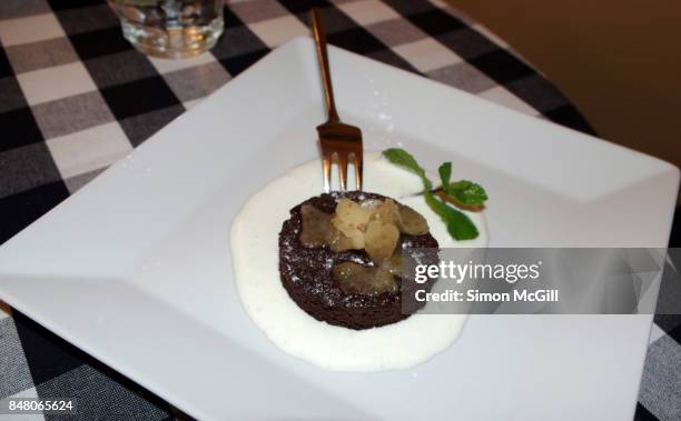 chocolate souffle with pear sorbet and marscapone cream - chocolate souffle stock pictures, royalty-free photos & images