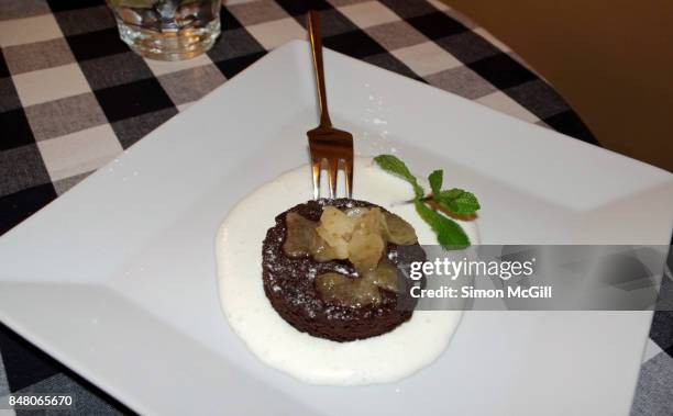 chocolate souffle with pear sorbet and marscapone cream - chocolate souffle stock pictures, royalty-free photos & images