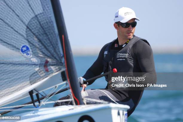 British Olympic Finn sailor Ben Ainslie on the water at the Weymouth and Portland National Sailing Academy.