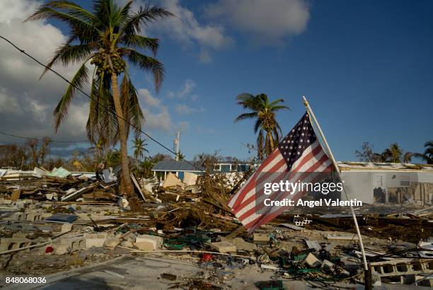 An American flag flies amid the destruction in the Sea Breeze trailer park in Plantation Key on September 16, 2017 in Marathon, Florida. Many places...