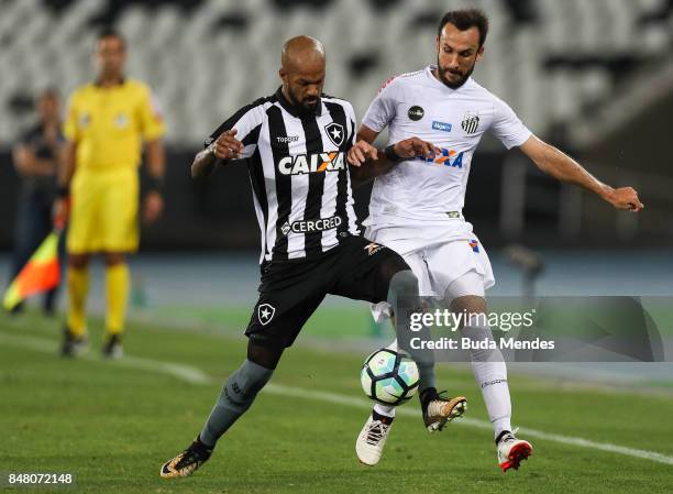 Bruno Silva of Botafogo struggles for the ball with Thiago Ribeiro of Santos during a match between Botafogo and Santos part of Brasileirao Series A...