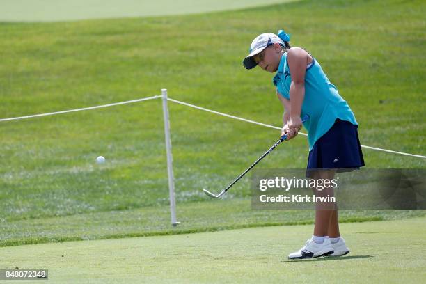 Mia Hammond hits a chip during the girls 10-11 chip competition during the Drive, Chip and Putt Championship at Muirfield Village Golf Club on...