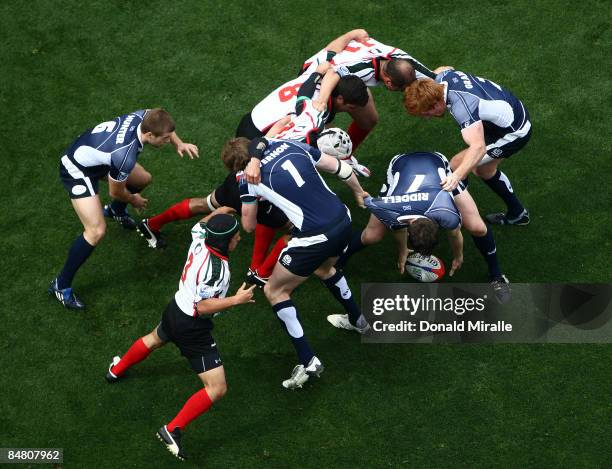Scott Riddell of Scotland grabs the ball in the scrum against the tackles of Mexico en route to Scotland's 50-0 victory in the Bowl Quarterfinal...