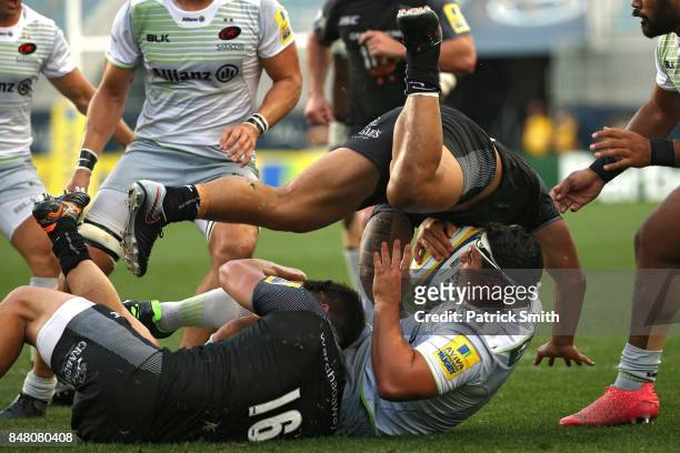Vereniki Goneva of the Newcastle Falcons tackles Kieran Longbottom of the Saracens during a Aviva Premiership match between the Newcastle Falcons and...