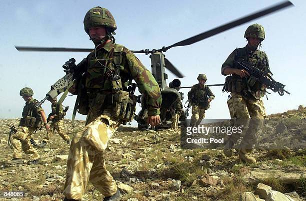 British Royal Marines of 45 Commando disembark a chinook helicopter while conducting vehicle stops and searches on June 26, 2002 in South Eastern...