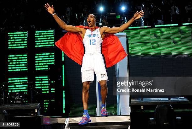 Dwight Howard of the Orlando Magic emerges from a phone booth wearing a Superman cape during the Sprite Slam Dunk Contest on All-Star Saturday Night,...