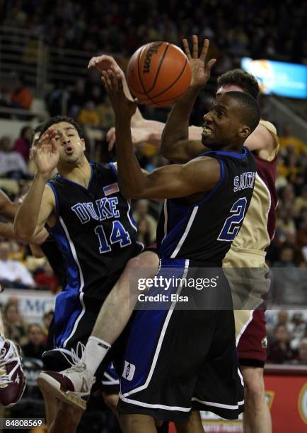 David McClure and Nolan Smith of the Duke Blue Devils fight for the rebound with Joe Trapani of the Boston College Eagles on February 15, 2009 at...