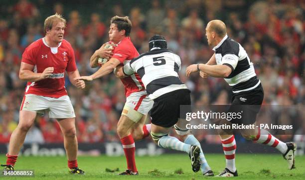 Wales' Lloyd Williams is tackled by Barbarians' Mark Chisholm during the International match at the Millennium Stadium, Cardiff.