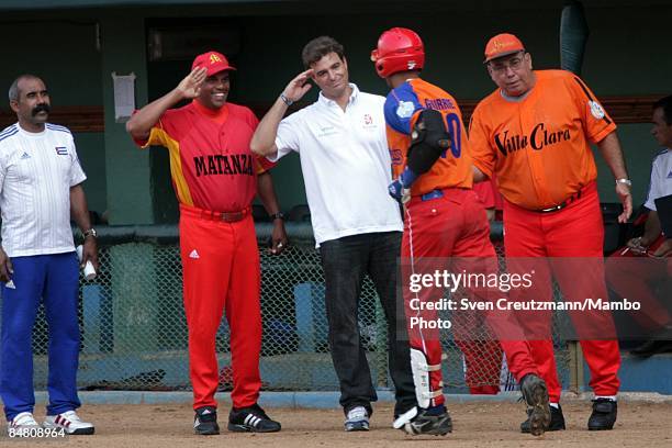 Antonio Castro , son of Cuban Revolution leader Fidel Castro, prepares for a high five with Yuliesky Gurriel after Gurriel's home run for the Oriente...