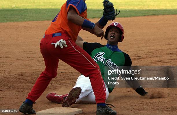 Jose Dariel Abreu of the Cienfuegos team is tagged out on third base during a training match of Cuba's National Baseball team, separated with an East...