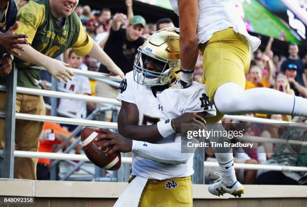 Brandon Wimbush of the Notre Dame Fighting Irish celebrates after rushing for a 65-yard touchdown during the fourth quarter against the Boston...