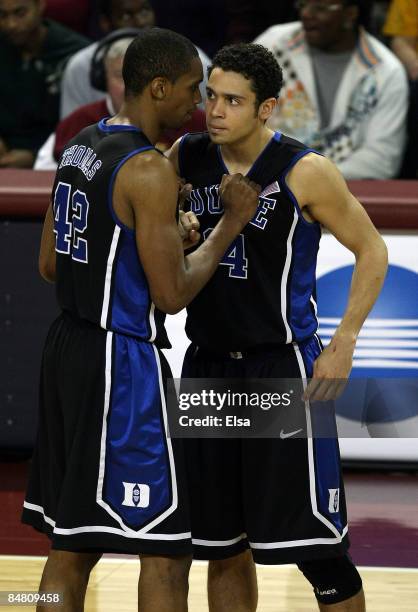 Lance Thomas of the Duke Blue Devils talks with his replacement David McClure after Thomas fouled out of the game the Boston College Eagles on...