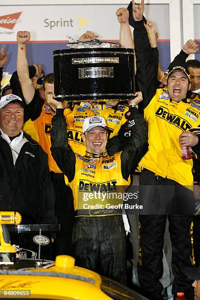 Matt Kenseth, driver of the DEWALT Ford, celebrates winning the NASCAR Sprint Cup Series Daytona 500 at Daytona International Speedway on February...