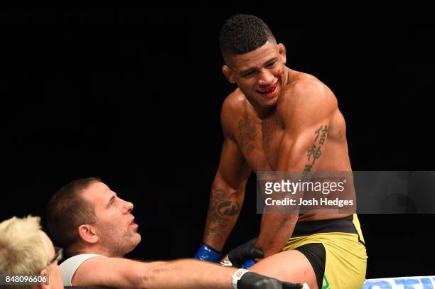 Gilbert Burns of Brasil celebrates with his coach Henri Hooft after knocking out Jason Saggo of Canada in their lightweight bout during the UFC Fight...