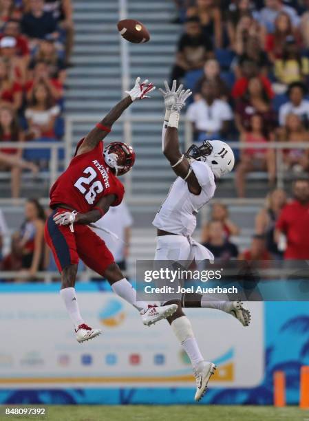 Chris Tooley of the Florida Atlantic Owls defends against Anthony Cruz of the Bethune Cookman Wildcats on September 16, 2017 at FAU Stadium in Boca...