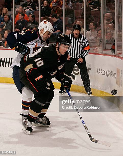 Marty Reasoner of the Atlanta Thrashers battles for the puck behind the net against Corey Perry of the Anaheim Ducks during the game on February 15,...