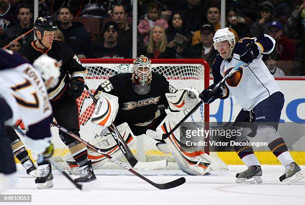 Bryan Little of the Atlanta Thrashers tries to the deflect the puck on a shot from the point by teammate Ilya Kovalchuk as goaltender Jean-Sebastien...