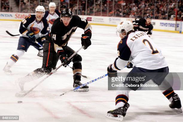 Garnet Exelby of the Atlanta Thrashers reaches for the puck against Bobby Ryan of the Anaheim Ducks during the game on February 15, 2009 at Honda...