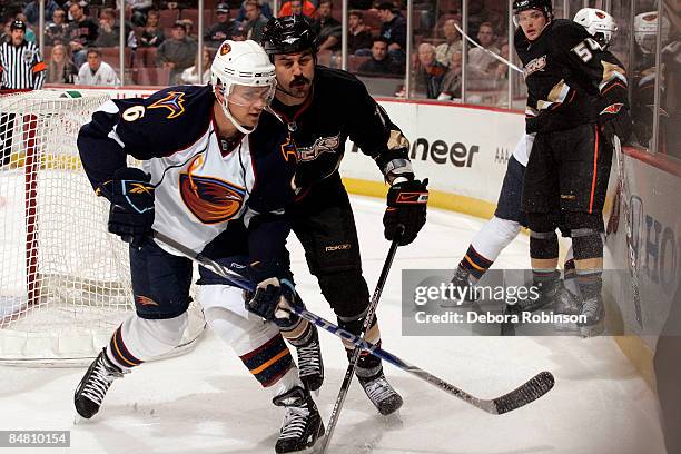 Ron Hainsey of the Atlanta Thrashers battles for the puck against George Parros of the Anaheim Ducks during the game on February 15, 2009 at Honda...