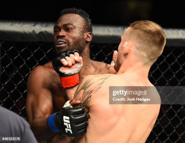 Krzysztof Jotko of Poland punches Uriah Hall of Jamaica in their middleweight bout during the UFC Fight Night event inside the PPG Paints Arena on...