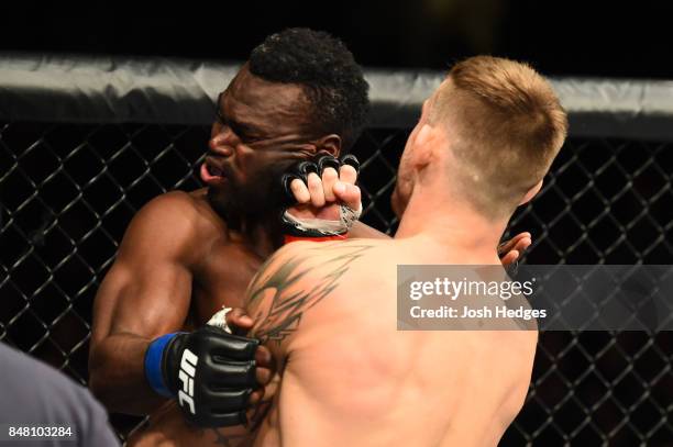 Krzysztof Jotko of Poland punches Uriah Hall of Jamaica in their middleweight bout during the UFC Fight Night event inside the PPG Paints Arena on...