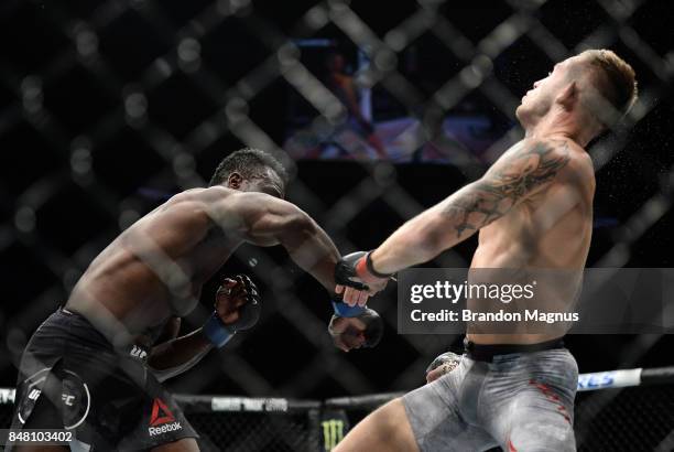 Uriah Hall of Jamaica punches Krzysztof Jotko of Poland in their middleweight bout during the UFC Fight Night event inside the PPG Paints Arena on...