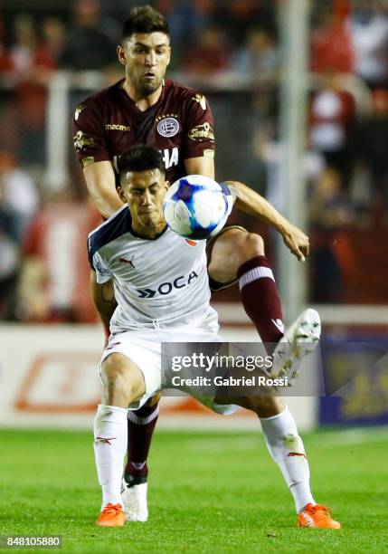 Diego Braghieri of Lanus fights for the ball with Maximiliano Meza of Independiente during a match between Independiente and Lanus as part of the...