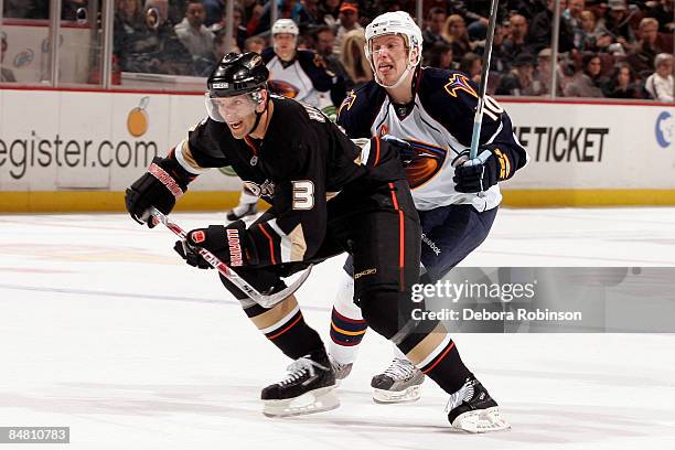 Bryan Little of the Atlanta Thrashers chases behind Bret Hedican of the Anaheim Ducks during the game on February 15, 2009 at Honda Center in...