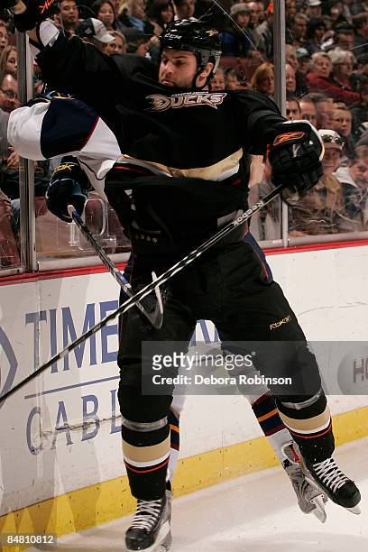 Colin Stuart of the Atlanta Thrashers is checked into the boards by Mike Brown of the Anaheim Ducks during the game on February 15, 2009 at Honda...