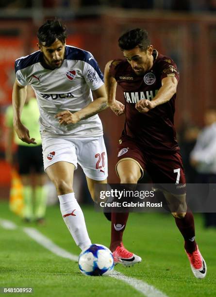 Lautaro Acosta of Lanus fights for the ball with Jonas Gutierrez of Independiente during a match between Independiente and Lanus as part of the...