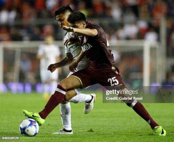 Marcelino Moreno of Lanus fights for the ball with Domingo Blanco of Independiente during a match between Independiente and Lanus as part of the...
