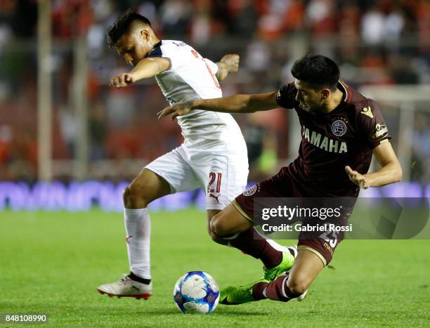 Marcelino Moreno of Lanus fights for the ball with Domingo Blanco of Independiente during a match between Independiente and Lanus as part of the...