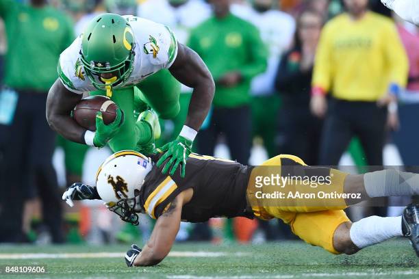 Marcus Epps of the Wyoming Cowboys tackles Royce Freeman of the Oregon Ducks during the first quarter on Saturday, September 16, 2017. The Wyoming...