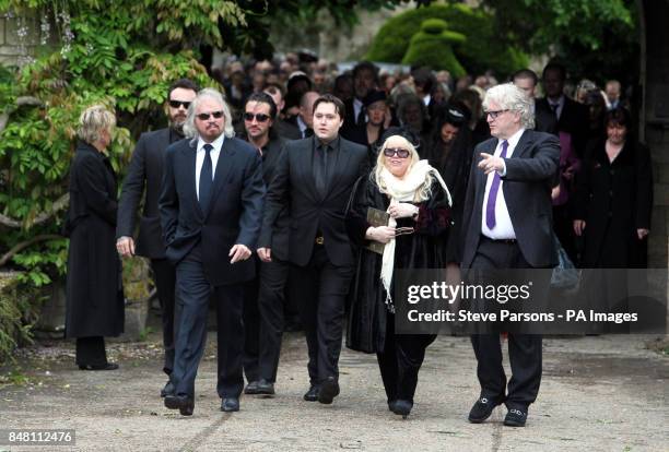 The family of Robin Gibb, including brother Barry and wife Dwina, follows his hearse as it leaves his home in Thame, Oxfordshire ahead of his funeral...