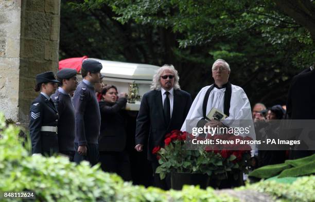 Bee Gee Barry Gibb walks in front of the coffin of his brother Robin Gibb as it is carried from his funeral service at St Mary's Church in Thame,...