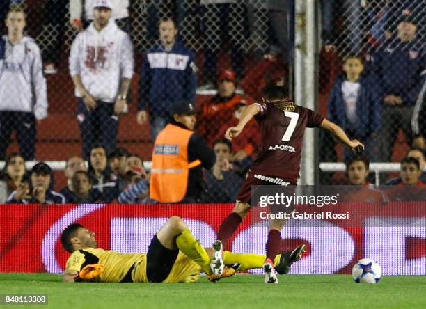 Martin Campaña goalkeeper of Independiente fouls Lautaro Acosta of Lanus leading to a penalty during a match between Independiente and Lanus as part...