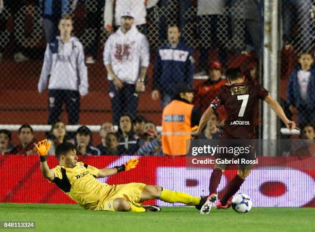 Martin Campaña goalkeeper of Independiente fouls Lautaro Acosta of Lanus leading to a penalty during a match between Independiente and Lanus as part...